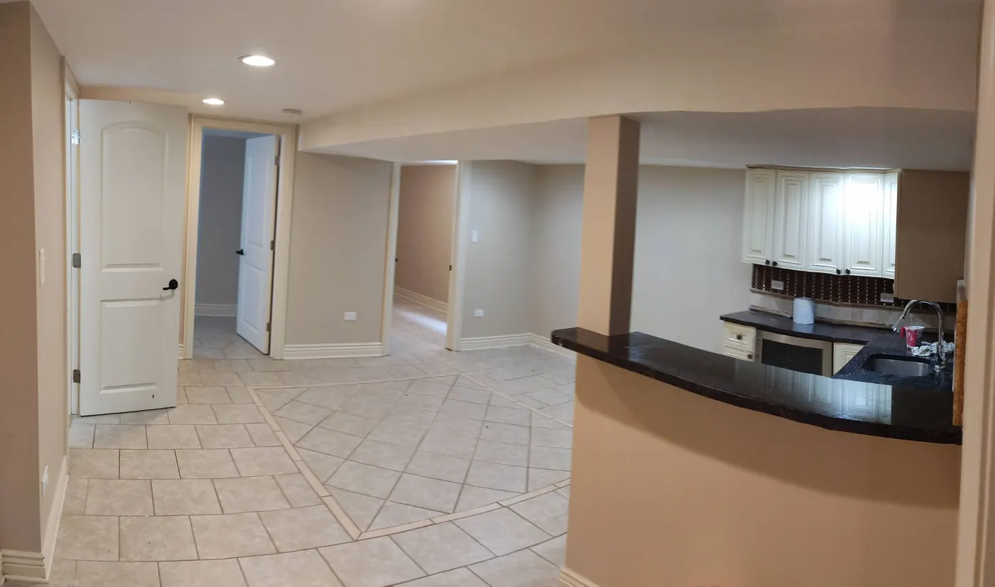 Finished basement with tile floor, kitchenette, and bar counter in Bloomingdale