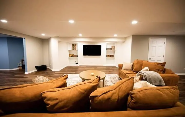 Finished basement living room with sectional sofa and built-in TV wall in Bloomingdale