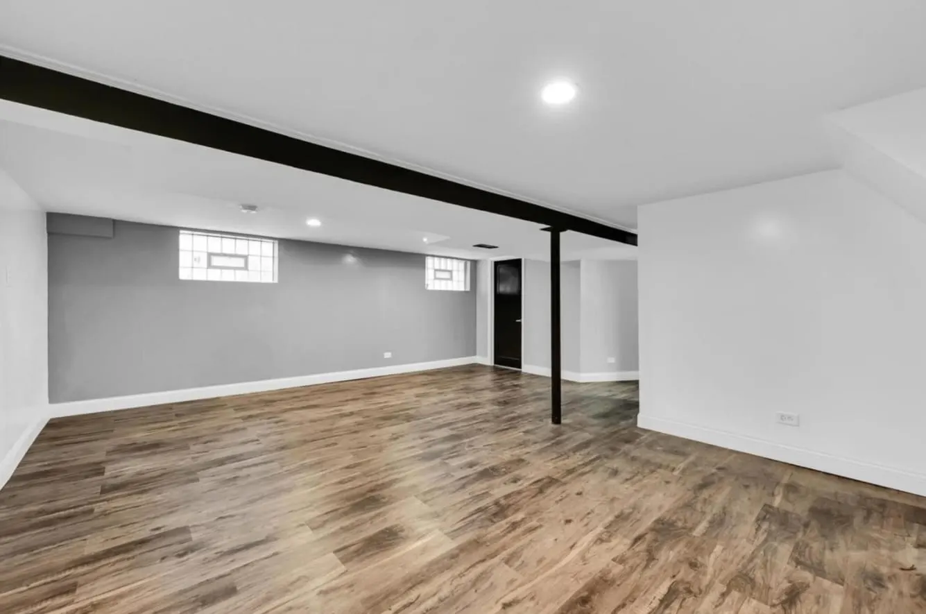 Basement finished with drywall, recessed lighting, and wood-look flooring in Bloomingdale