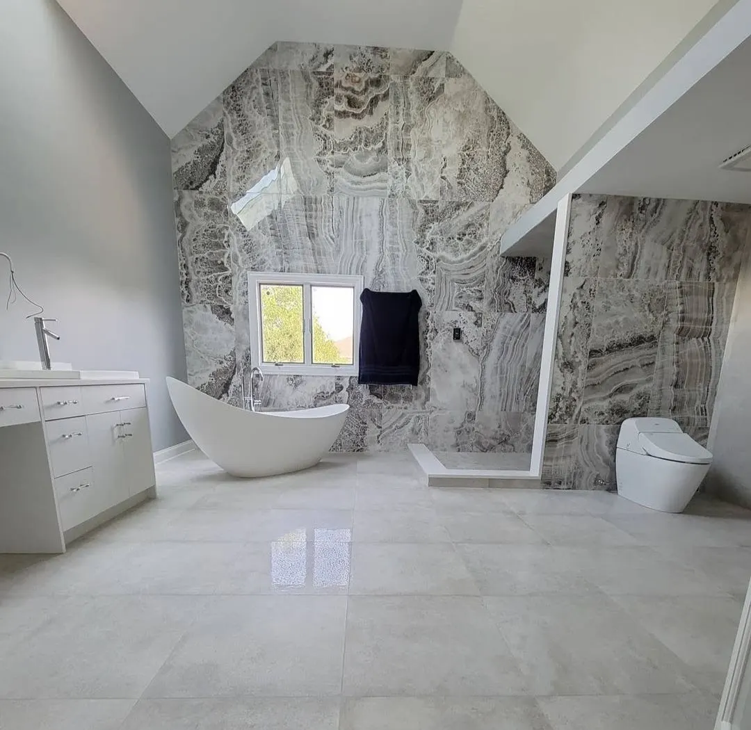 Full bathroom remodel with freestanding tub, stone feature wall, and walk-in shower in Bloomingdale