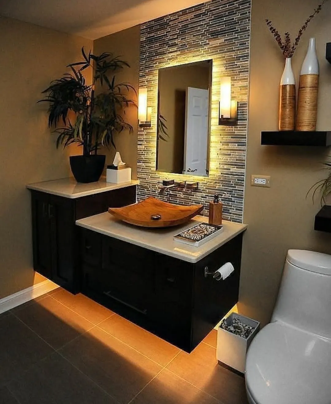 Bathroom remodel with floating dark vanity, vessel sink, and backlit mosaic tile wall in Bloomingdale
