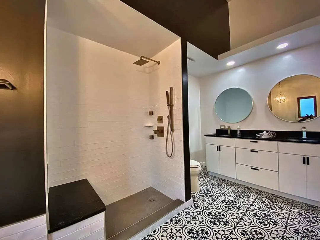 Bathroom remodel with white subway tile walk-in shower and black-and-white patterned floor tile in Bloomingdale