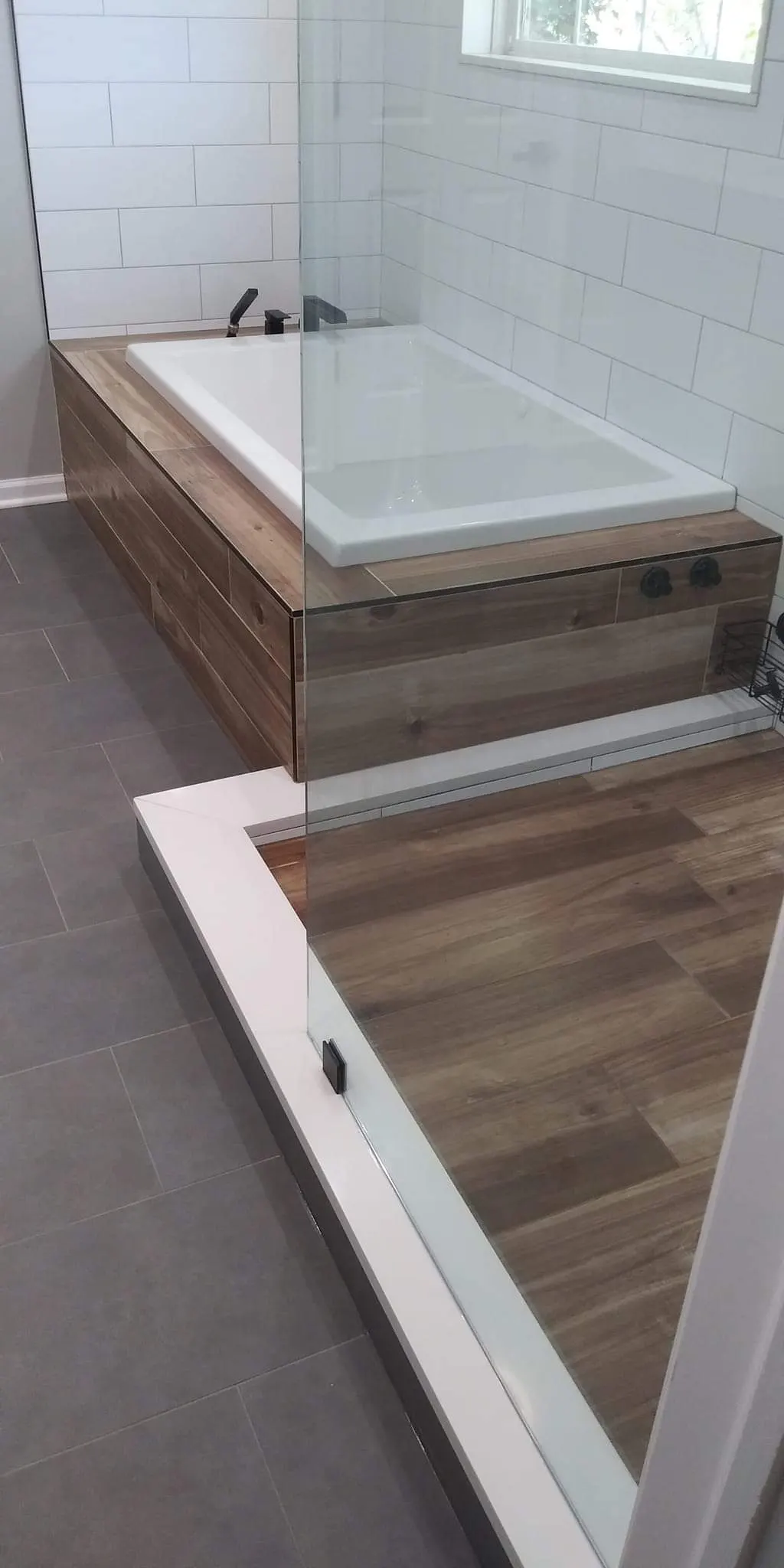 Basement bathroom addition with glass shower in Glendale Heights