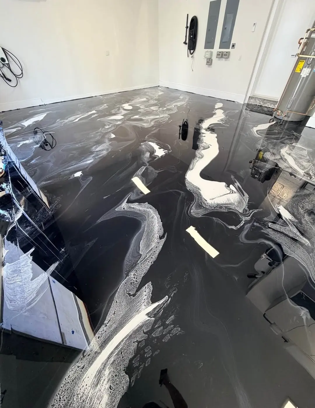 Black and white metallic epoxy floor in a garage