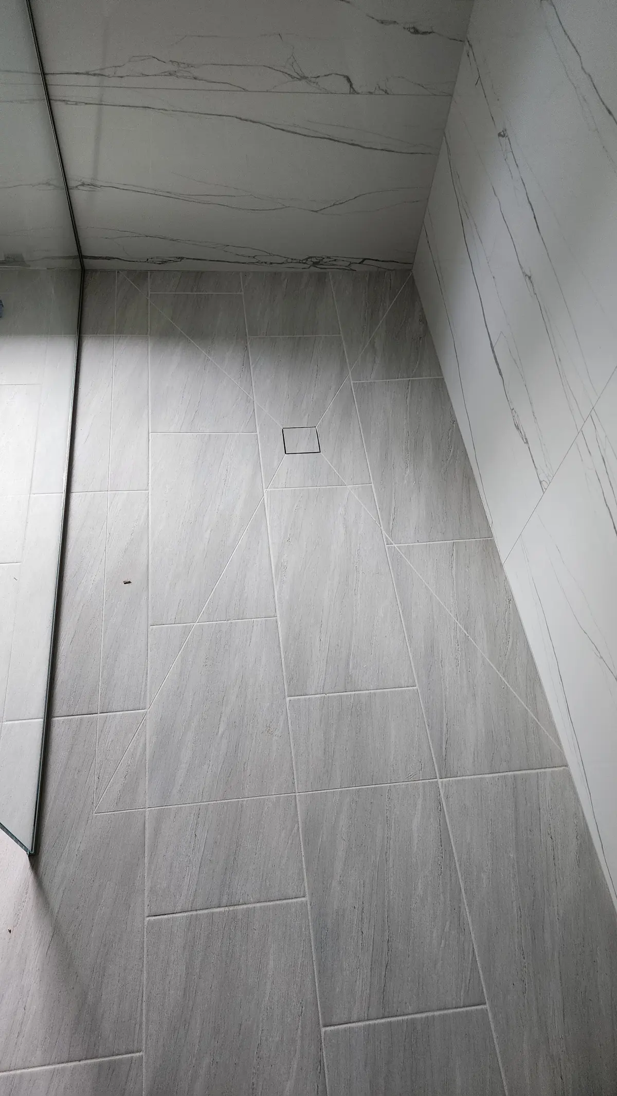 Gray wood-look plank tile floor installed in a bathroom