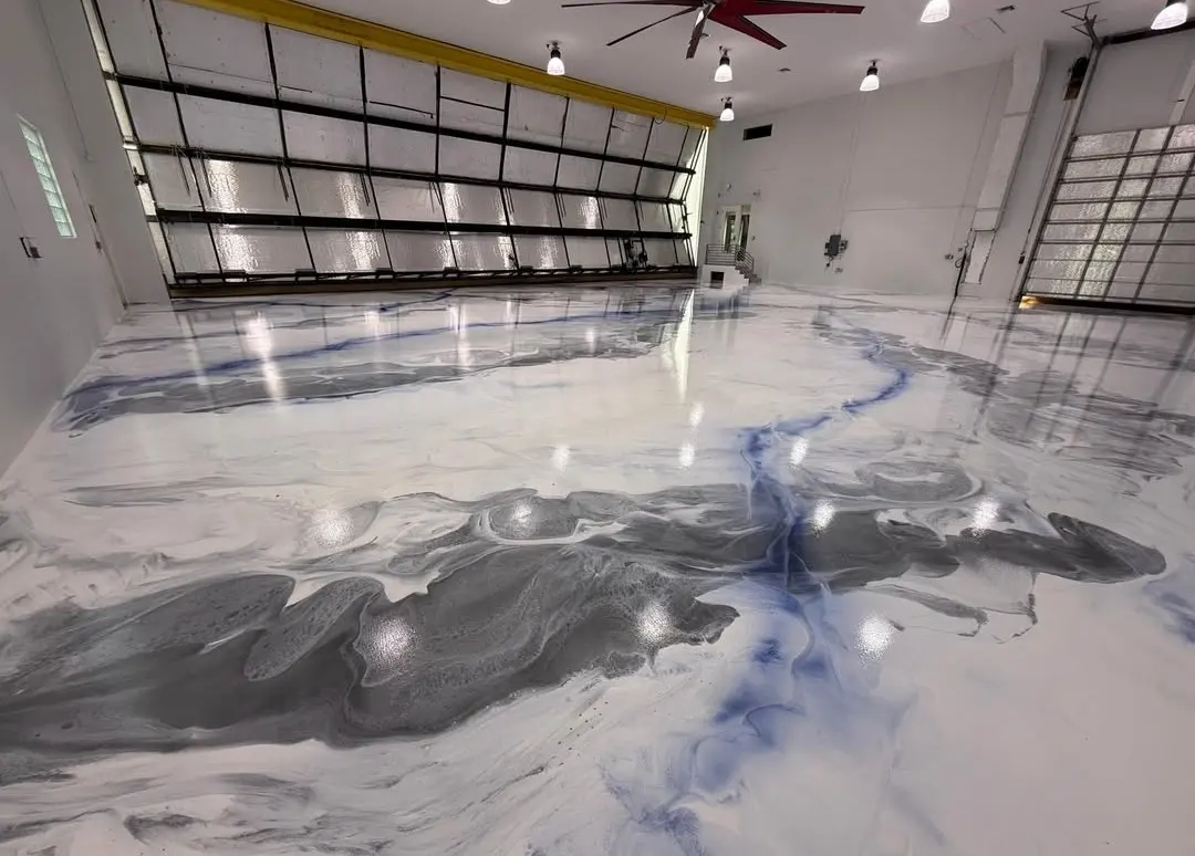 Large garage with a glossy blue and gray metallic epoxy floor