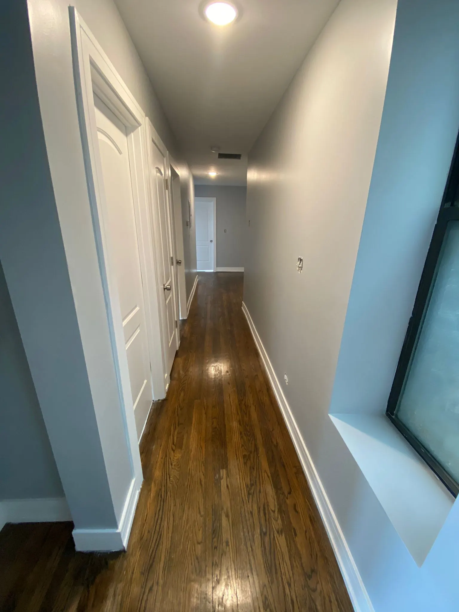 Refinished hardwood hallway floor in Glendale Heights home