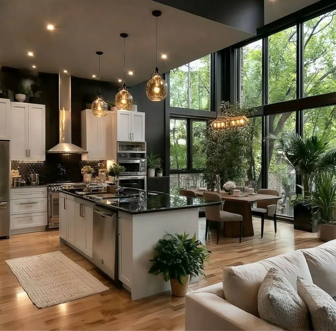 Open concept kitchen with white cabinets, dark countertop island, and pendant lights in Bloomingdale
