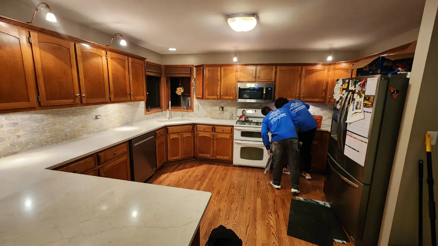 Kitchen remodel with wood cabinets, stone tile backsplash, and quartz countertops in Bloomingdale