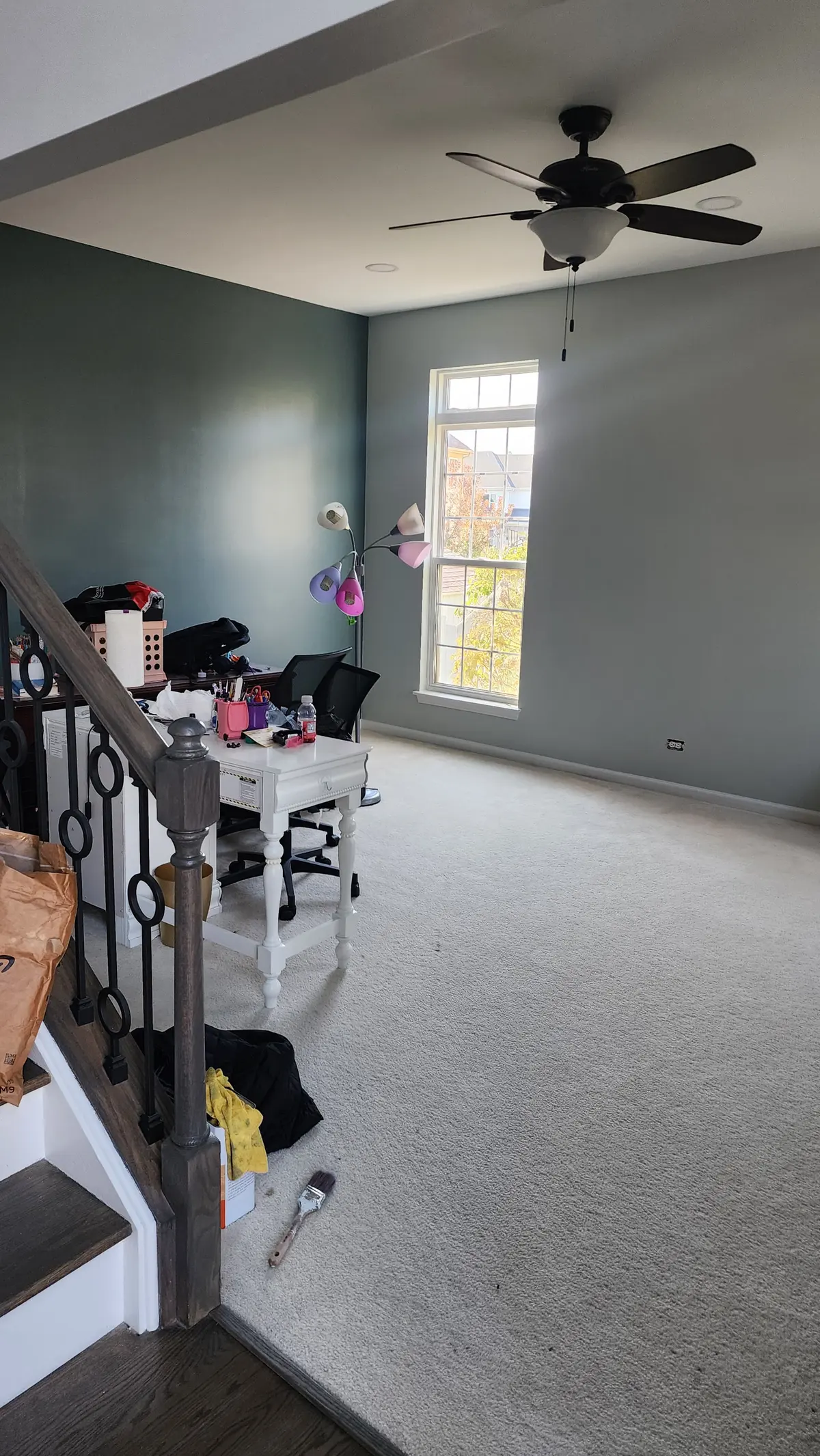 Upstairs room with freshly painted gray-green walls and a ceiling fan
