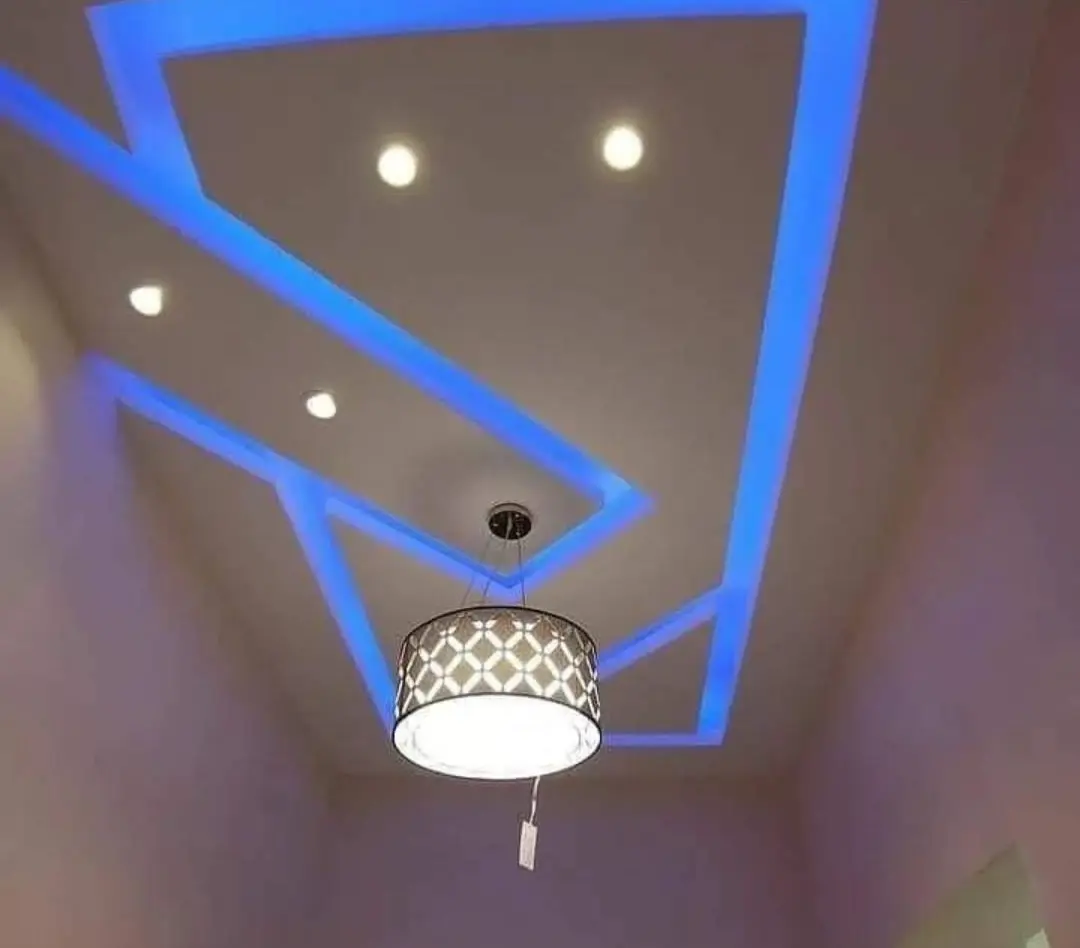 Painted ceiling with blue LED cove lighting, recessed lights, and a pendant