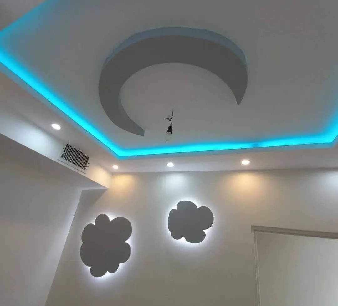 Painted ceiling with blue cove lighting and cloud-shaped wall accents