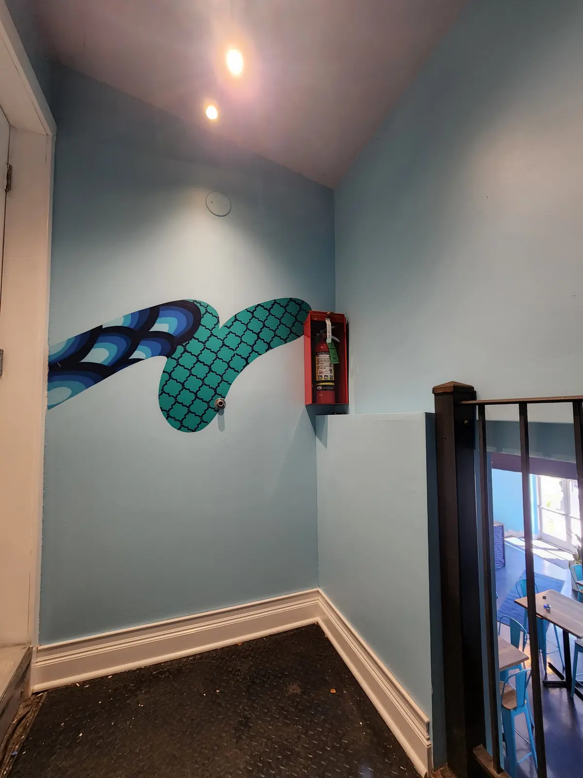 Light blue painted walls with crisp white trim at a hallway corner