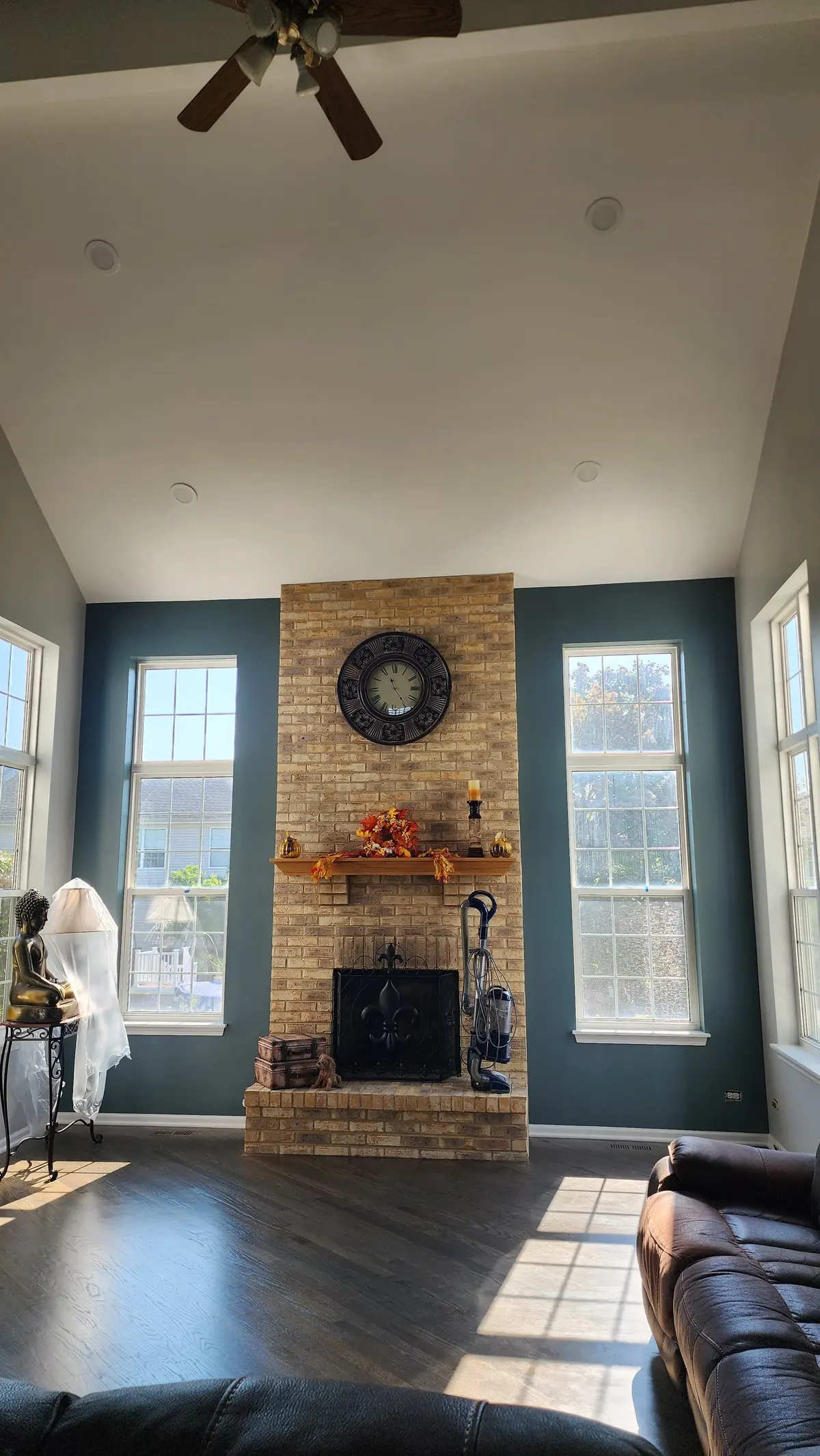 Living room with painted blue-gray walls around a brick fireplace in Bloomingdale