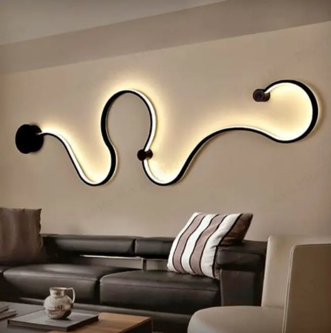 Living room wall with a sculpted LED wall light over a leather sofa
